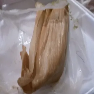 a tamales in a plastic container