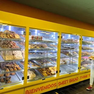 a woman standing in front of a bakery