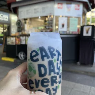 a hand holding a cup of coffee