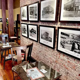 Some old wooden tables alongside the restored brick wall. The photos are Nihonmachi pre-WWII.