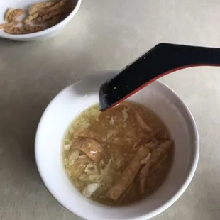 Egg drop soup cup with crunchy things added. One cup comes included before the entree.