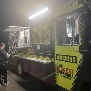 a man standing in front of a food truck