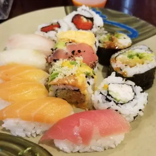 a plate of sushi and rolls