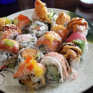 a plate of sushi and rolls