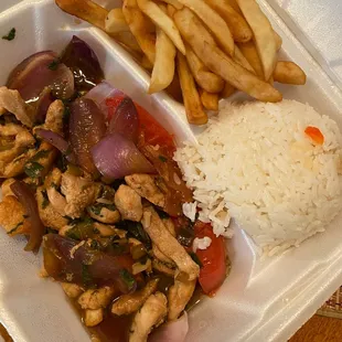 chicken, rice, and french fries in a styrofoam container