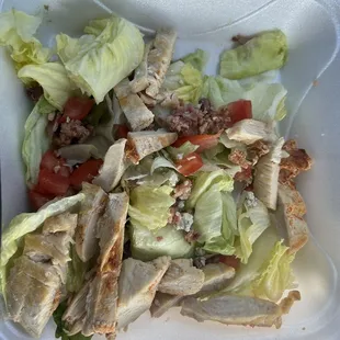 a salad in a styrofoam container