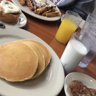 Chocolate French toast, pancakes, sausage, bacon, cinnamon roll, OJ, white milk