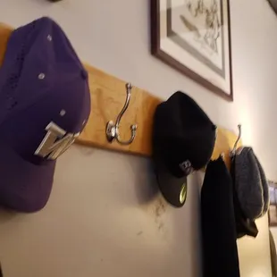 a coat rack with hats on it