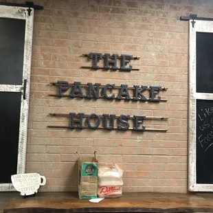 the pancake house sign on a brick wall