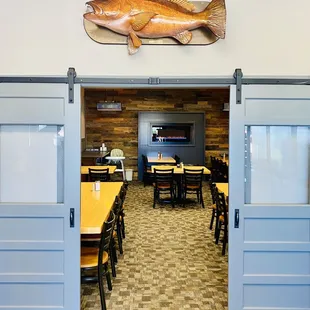 a dining room with a fish on the wall
