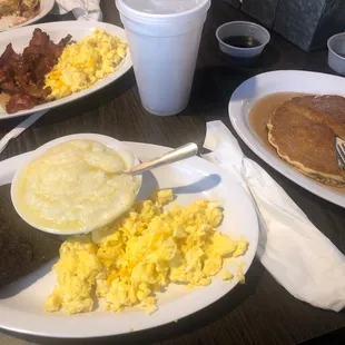 Breakfast plate pancake eggs scrambled with cheese livermush and grits