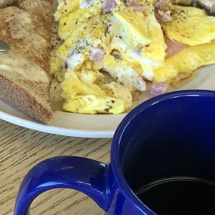 a plate of breakfast food and a cup of coffee