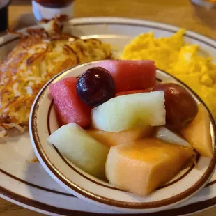 a plate of fruit and eggs