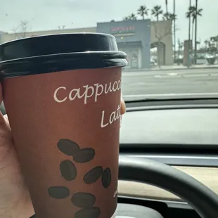 a person holding a cup of coffee