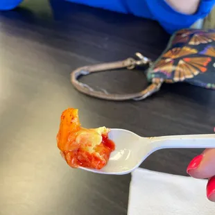 a person holding a spoon full of ice cream