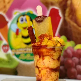 Mangonada delux. Mango sherbet with chamoy and tajin topped with mango chunks and Mangonada paleta