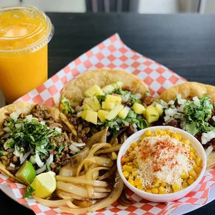 Asada,al pastor and chorizo tacos with our mango agua fresca and street corn