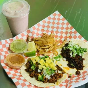 Al pastor and chorizo taco on flour tortilla . With an strawberry agua fresca
