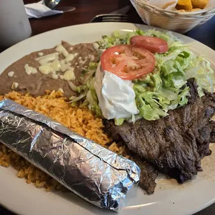 Carne Asada Plate , come with Mexican rice, refried beans,  lettuce tomoto3s and sour cream.