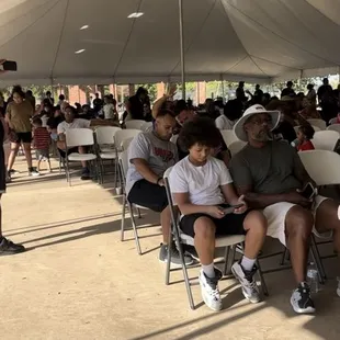 People in line to eat burgers hot dogs and nachos  The nachos were donated from panchitos