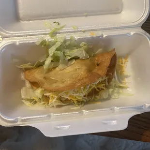 a close up of a sandwich in a styrofoam container