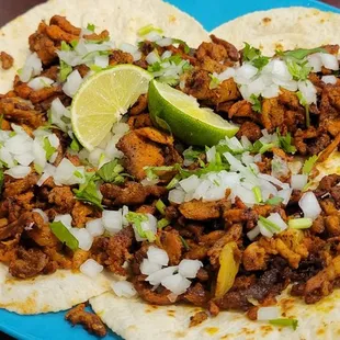 two plates of tacos on a table