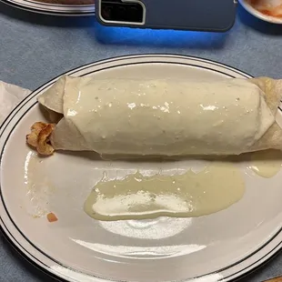 a person taking a picture of a burrito