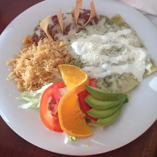 Enchiladas Verde (red sauce available too!) with Rice and Beans and a small salad. Vegetarian friendly.