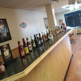 a long bar lined with bottles of beer