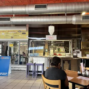 people sitting at tables in a restaurant