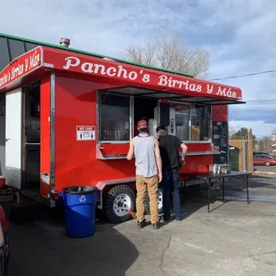 a man standing in front of a food truck