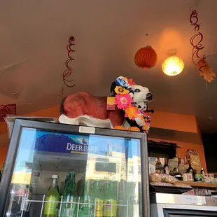 a stuffed animal on top of a refrigerator