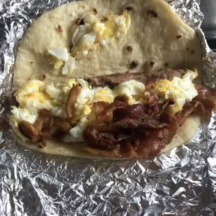 a breakfast burrito wrapped in foil