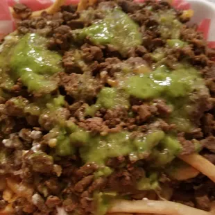 Carne asada fries with salsa verde sauce on top