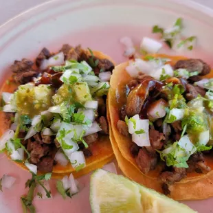 two tacoss on a plate