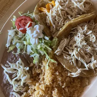 Chicken tacos with a side of rice and beans