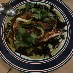 Farm pork chop strips, mushrooms, verde sauce on greens