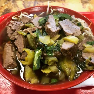 Beef noodle soup with pickled cabbage.