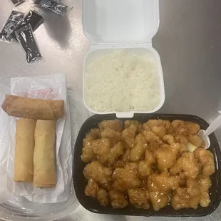 a tray of food and a container of rice