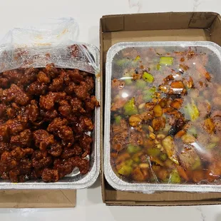 Half trays of orange chicken and kung pao chicken.
