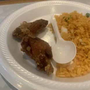 a plate of food with rice and meat