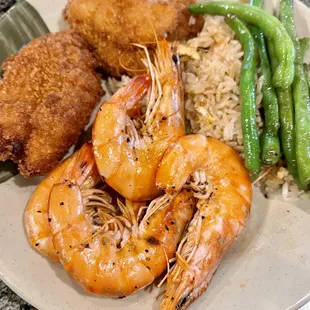 a plate of fried shrimp, rice, and green beans