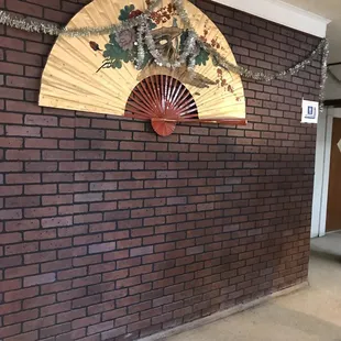 a brick wall with a fan on it