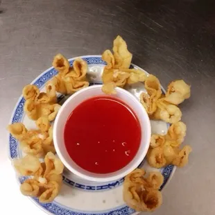 a bowl of dipping sauce on a plate