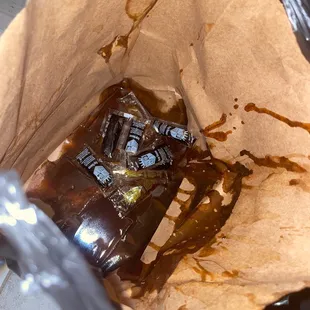 a bottle of beer in a paper bag