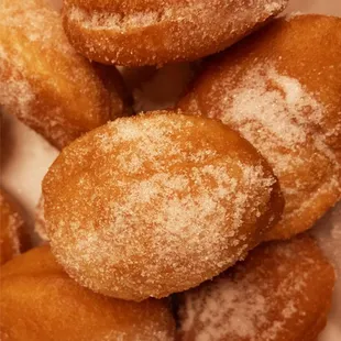 a pile of sugar coated donuts
