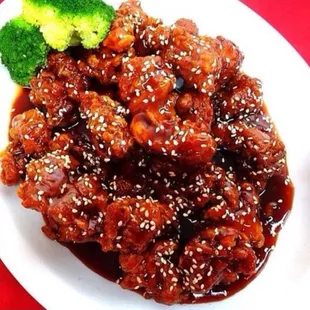 a plate of meat and broccoli