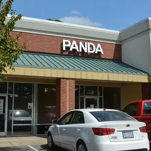 a white car parked in front of the restaurant