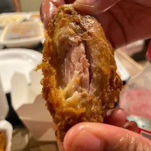 a person holding a piece of food