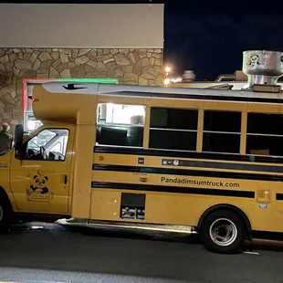 a yellow school bus at night